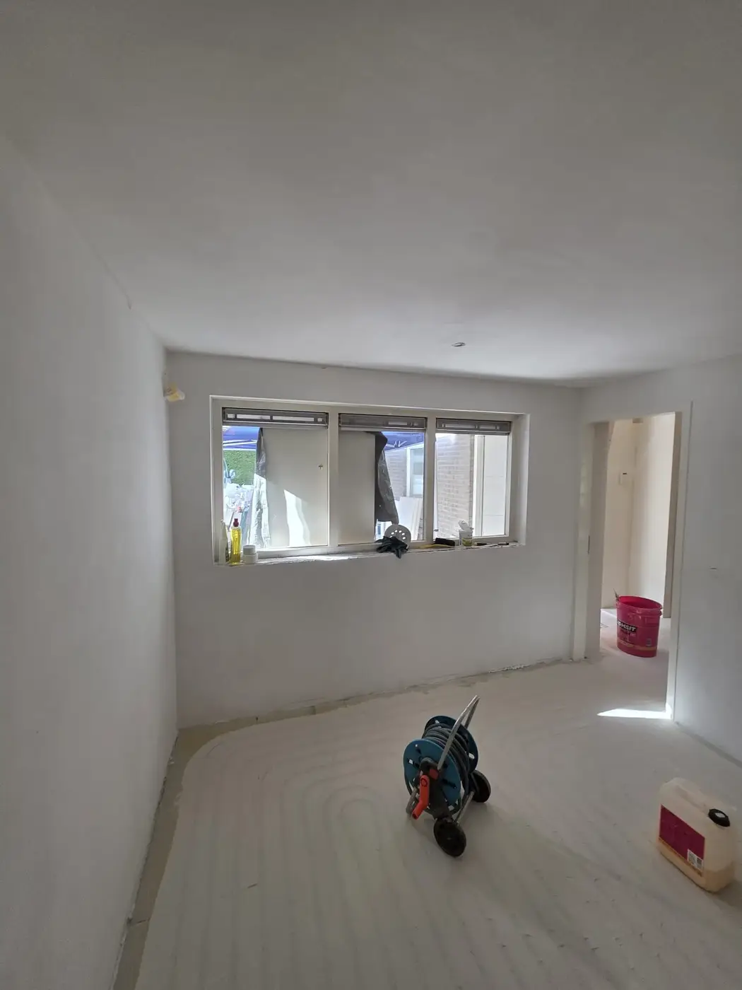 Werkkamer met raampartij, wanden en plafond glad gestuukt
